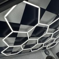 Hexagon SMG LED Lighting illuminating a garage space, showcasing its modular and eye-catching design