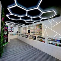Hexagon SMG LED Lighting illuminating a garage space, showcasing its modular and eye-catching design